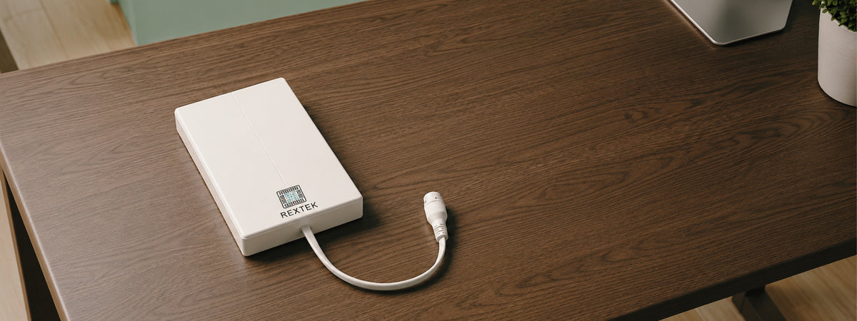 Saurian X62 modem sitting on a dark wood table with its white Ethernet cable plugged in, REXTEK logo visible on the front panel.